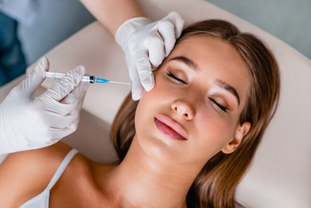 Young woman gets botox injections in salon