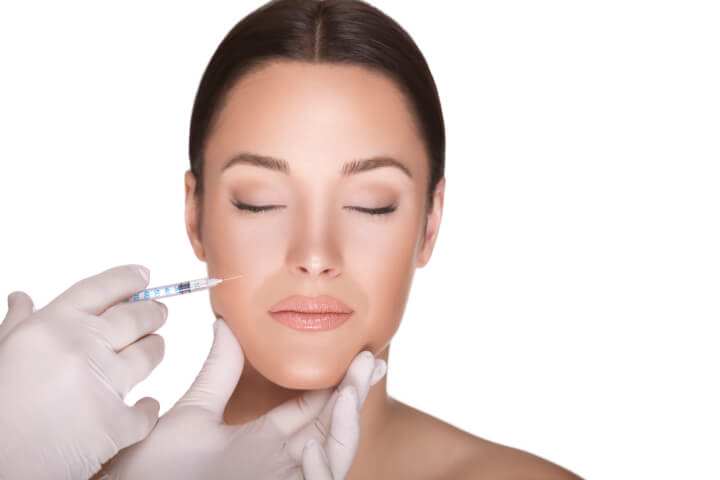 woman receiving cheek filler injection 