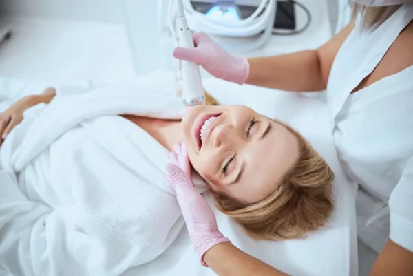 woman enjoying microneedling procedure on her neck