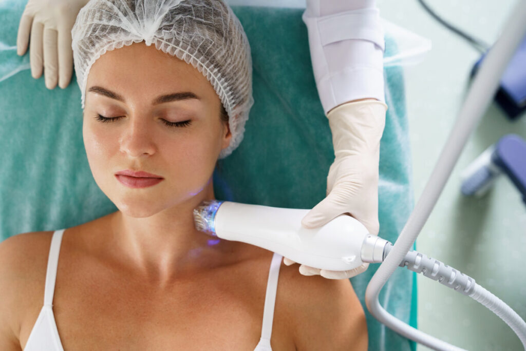 woman getting rf microneedling treatment done on her neck